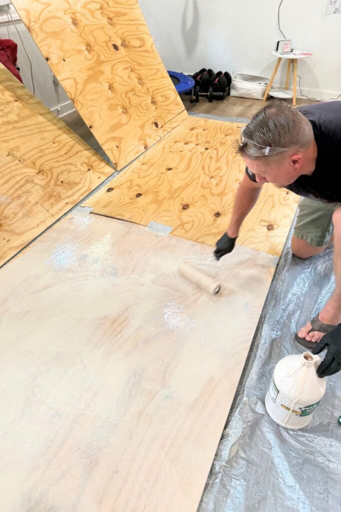 Applying glue to boards with paint roller