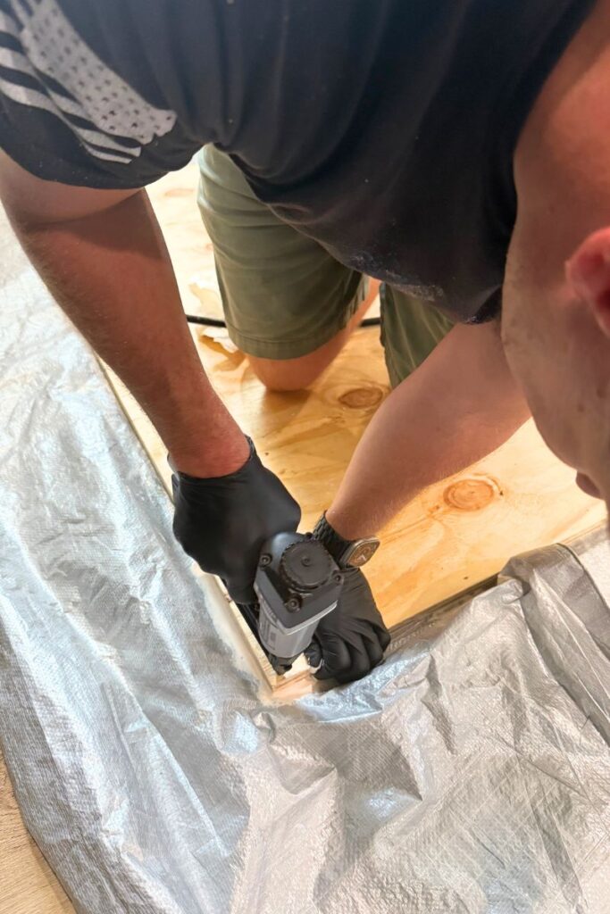 Applying nails to board with nail gun