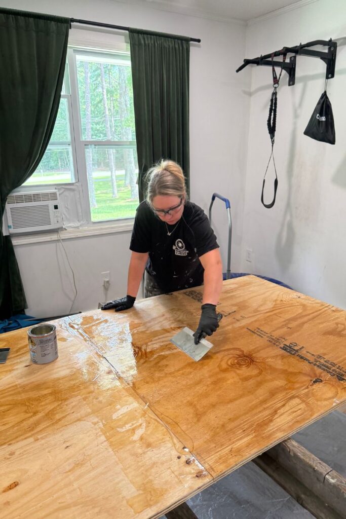 Applying waterproofing glue for the camper floor replacement board
